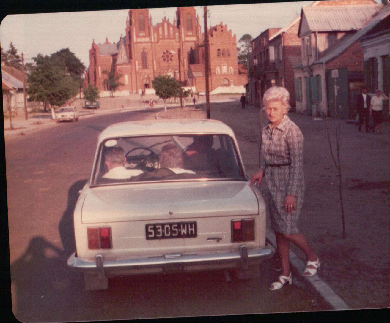 Bridget Krysiak standing by their car in Poland visit 1973 001.JPG